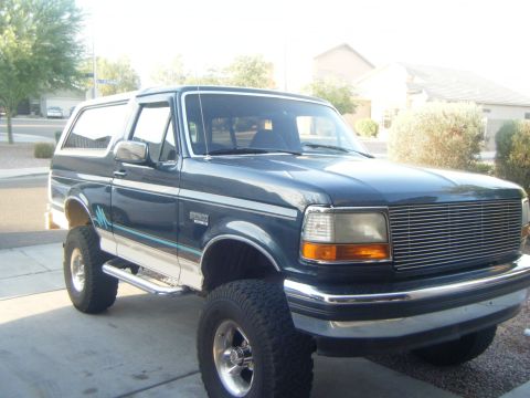 1993 Ford Bronco - This lifted Ford Bronco is parked in a driveway on a sunny day.