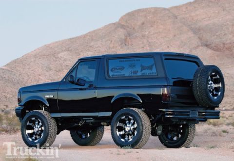 1993 Ford Bronco - This lifted 1993 Ford Bronco is shown in a desert setting with aftermarket wheels and a spare tire mounted externally.
