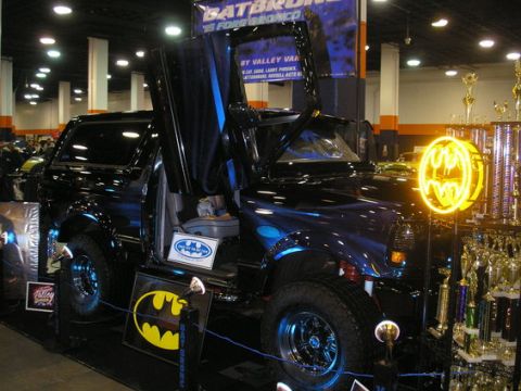 1993 Ford Bronco - This customized Ford Bronco features gullwing doors and Batman-themed decorations, displayed with numerous trophies.