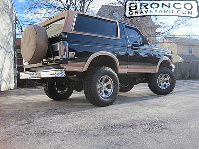 1993 Ford Bronco - This lifted Ford Bronco has a two-tone paint job and a spare tire mounted on the rear tailgate.