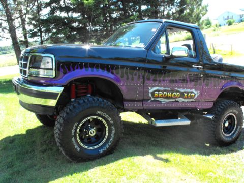 1993 Ford Bronco - Customized 1993 Ford Bronco XLT, lifted with flame graphics and custom side decal.