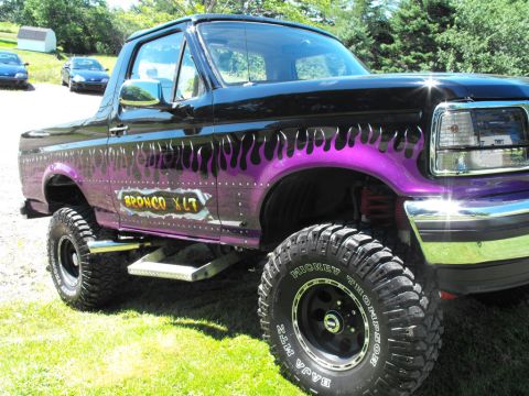 1993 Ford Bronco - This modified Ford Bronco features a custom flame paint job and off-road tires.