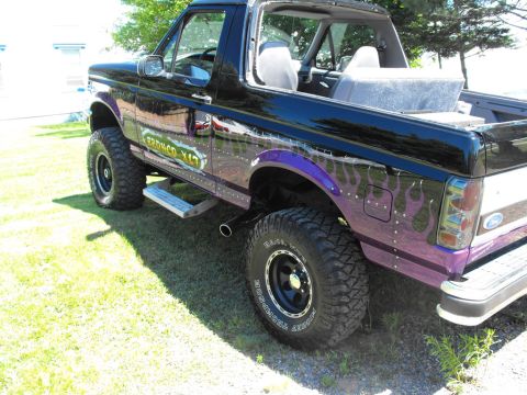 1993 Ford Bronco - This 1993 Ford Bronco features custom purple flame graphics and a lifted suspension.