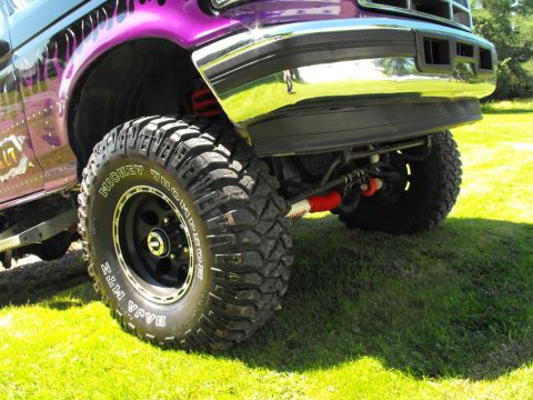 1993 Ford Bronco - This lifted truck features custom purple flame graphics and aggressive Mickey Thompson Baja MTZ tires.