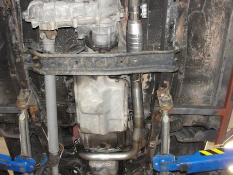 1993 Ford Bronco - Underside view reveals the transmission, exhaust system, and suspension components of a vehicle.