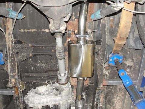 1993 Ford Bronco - Close-up of the exhaust system components underneath a vehicle.