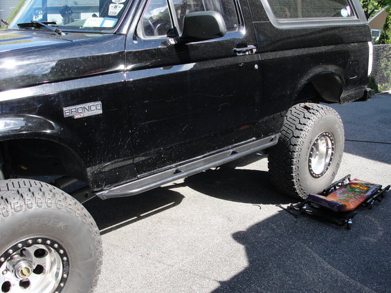 Black lifted Ford Bronco side view showing tubular side step and large off-road tires
