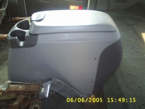 1993 Ford Bronco - Center console from a vehicle, showing cup holders and storage.