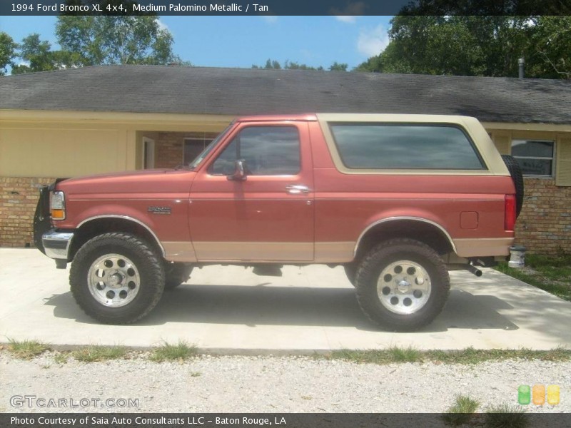 Side view of a 1994 Ford Bronco in red and tan