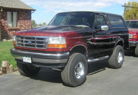 1993 Ford Bronco - This 1993 Ford Bronco features a custom flame paint job on the hood and a chrome grille.