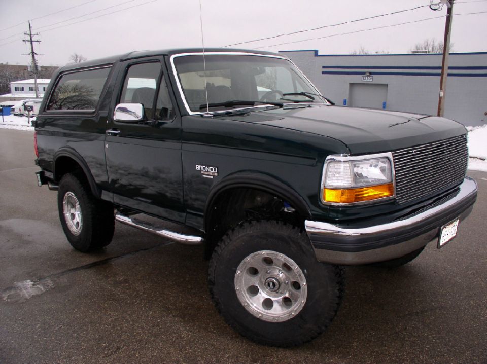 Dark green 1993 Ford Bronco parked on asphalt, front quarter view