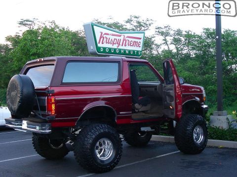 1993 Ford Bronco - This lifted 1993 Ford Bronco is parked outside a Krispy Kreme, showing off its custom wheels and tires.