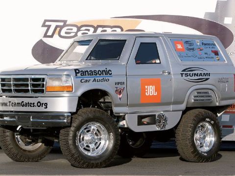 1993 Ford Bronco - This heavily modified Ford Bronco features extensive branding for audio companies and a lifted suspension.
