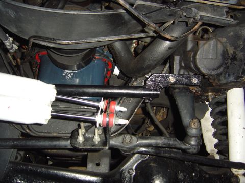 1986 Ford Bronco - Undercarriage view showing steering linkage, shock absorber, and engine components.