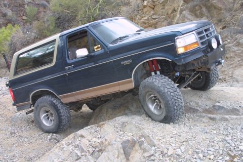1994 Ford Bronco - 1994 Ford Bronco tackling a challenging rocky off-road course.