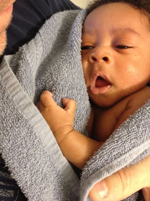 2010 Subaru Legacy - A baby is being held and wrapped in a towel.