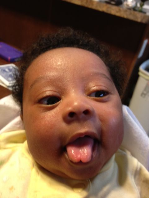 2010 Subaru Legacy - A baby's face is shown in a close-up, with its tongue sticking out playfully.