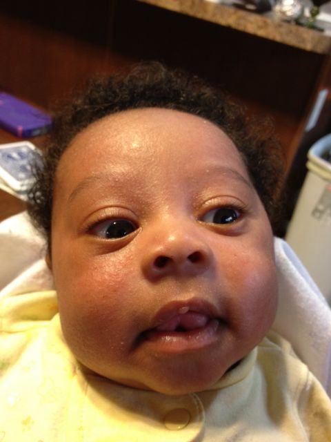 2010 Subaru Legacy - Baby's face close-up, looking to the side with tongue visible.