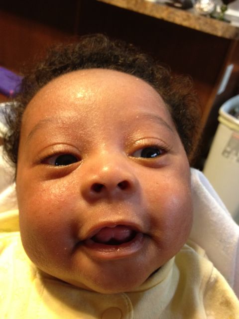 2010 Subaru Legacy - A close-up shot captures a baby's face with a curious expression, showing their eyes, nose, and mouth.