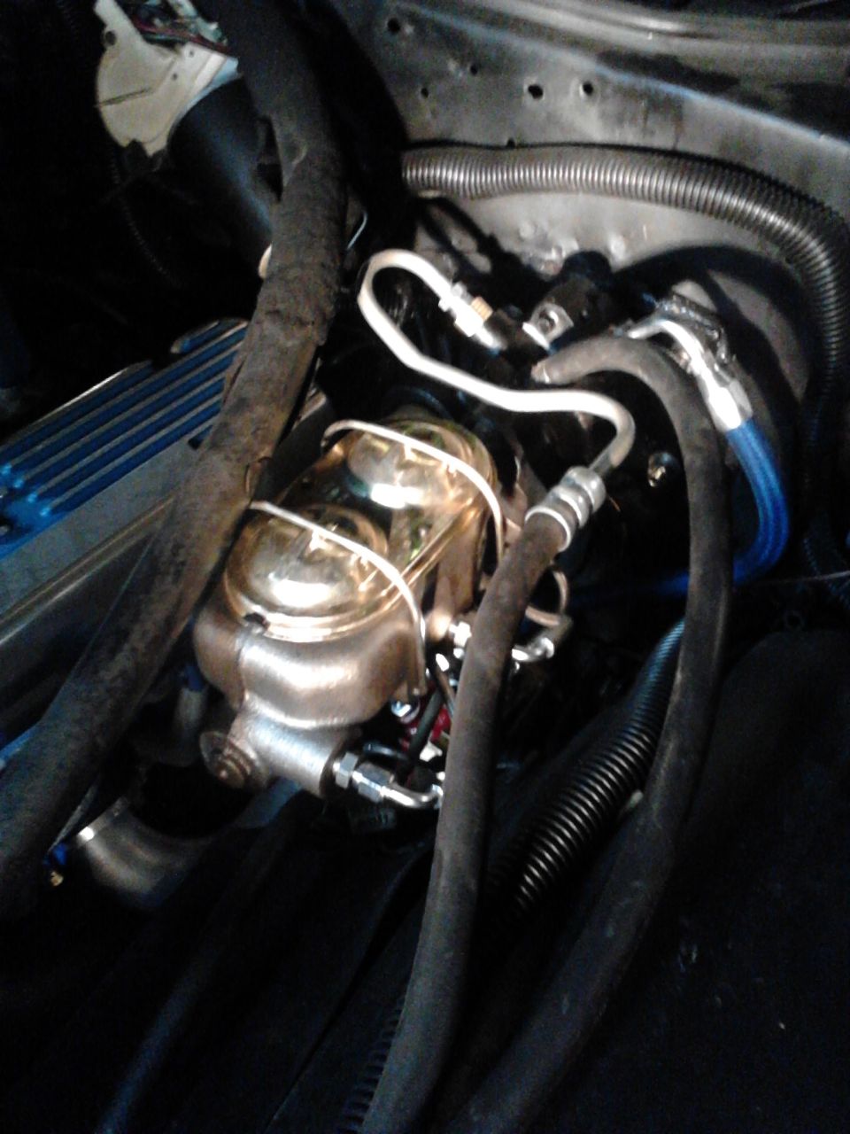Corvette 1 1/8" MC attached to '93 Astro Van hydroboost unit. Custom bracket, hoses and pushrod were made for installation. Pic also shows new output hose (blue pressure hose) to steering gear.
