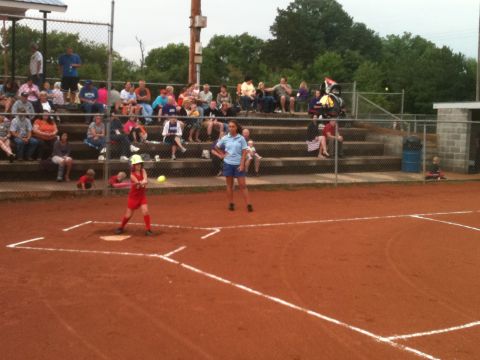 1992 Ford Bronco - A softball game is in progress with spectators in the bleachers and a batter at home plate.