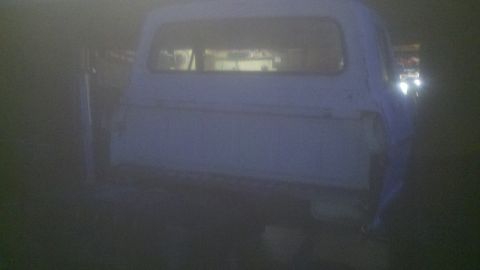 1967 Ford F-250 - This 1967 Ford F-250 pickup truck is seen from the rear, possibly in a workshop or garage.
