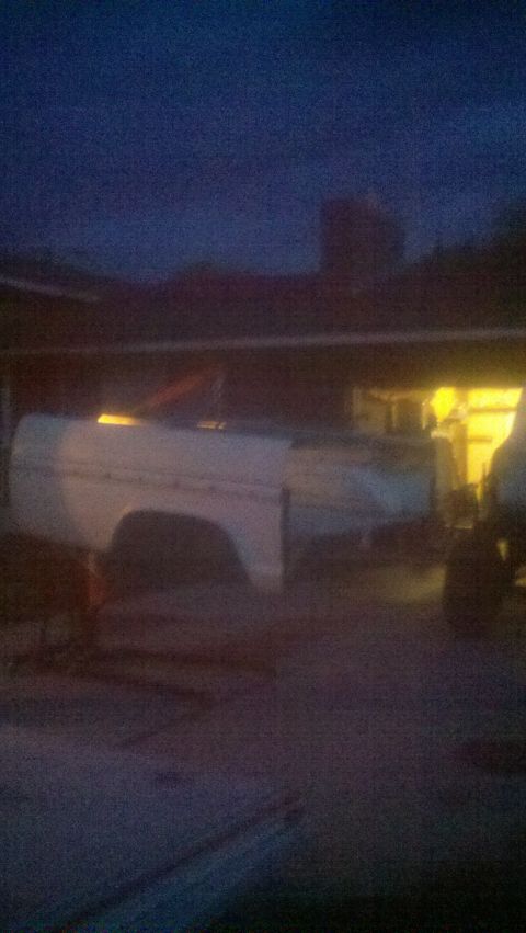 1967 Ford F-250 - A white truck bed and fender assembly is visible in the dim light of dusk.