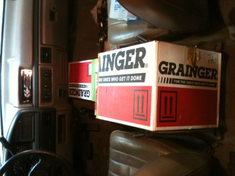 1992 Ford Bronco - Boxes of supplies are stored inside the cab of a truck.