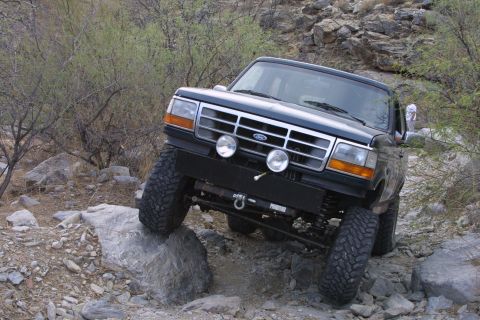 1994 Ford Bronco - Ford Bronco navigates a rocky, off-road trail.