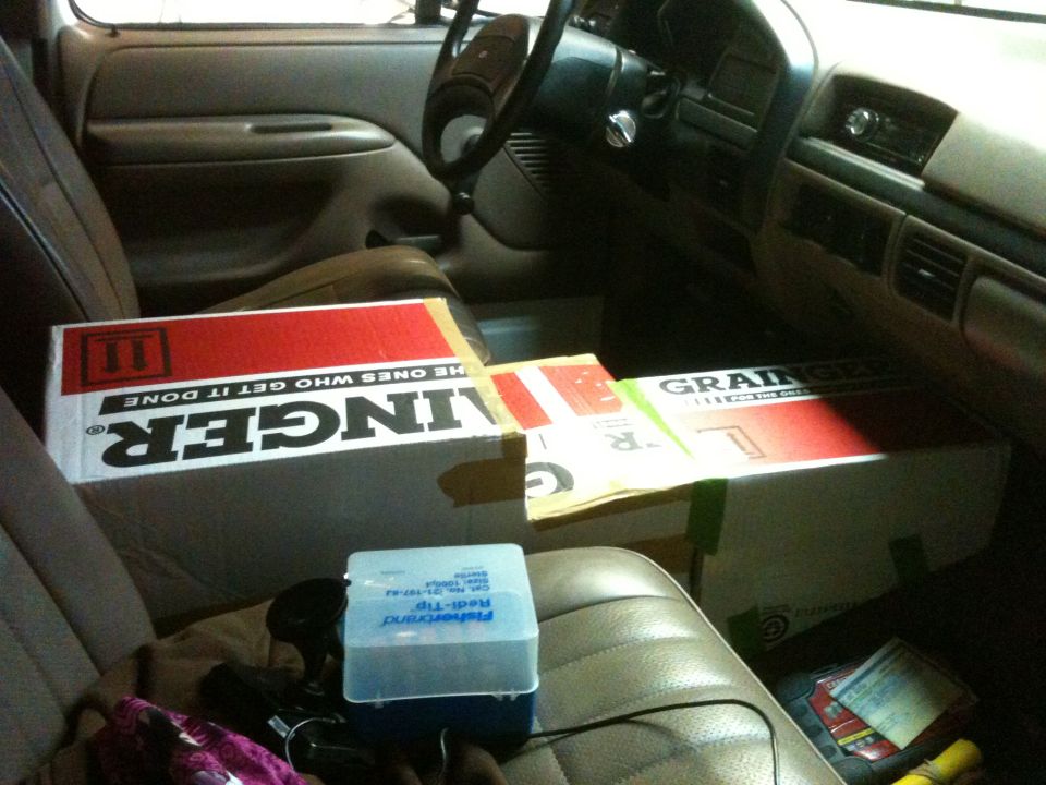 Interior view of vehicle with boxes on seats