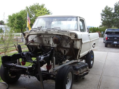 1967 Ford F-250 - A white 1967 Ford F-250 truck chassis is shown outdoors with its front end disassembled.