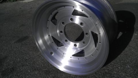 1989 Ford Bronco - Close-up of a single aluminum alloy wheel with a distinctive spoke design.