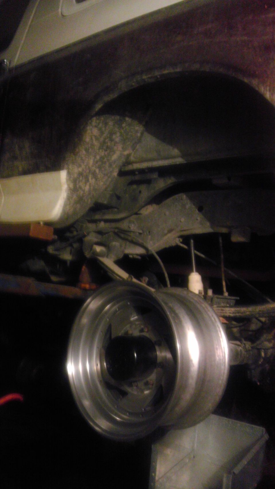 Rear axle with custom wheels and suspension components visible