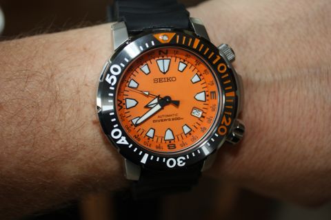 1986 Ford Bronco - Seiko automatic diver's watch with orange dial and rotating bezel is worn on a wrist.