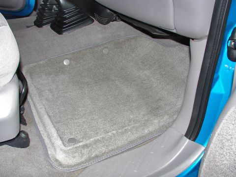 1998 Ford F-150 - Close-up view of the driver's side floor mats and interior trim.