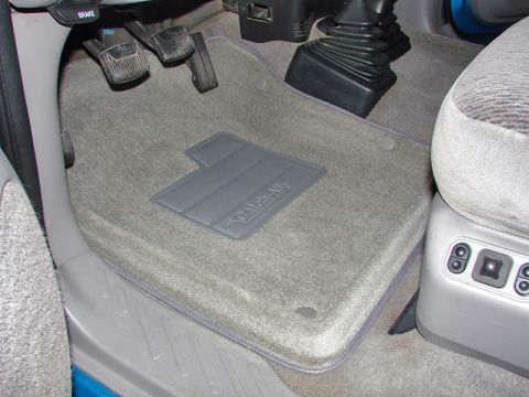 1998 Ford F-150 - Close-up of gray floor mats with the 'Catch-All' logo, showing pedals and part of a seat.