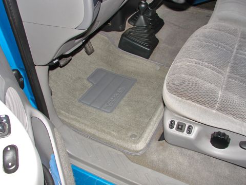 1998 Ford F-150 - Interior view of a 1998 Ford F-150, focusing on the driver's side floor mat and seat.