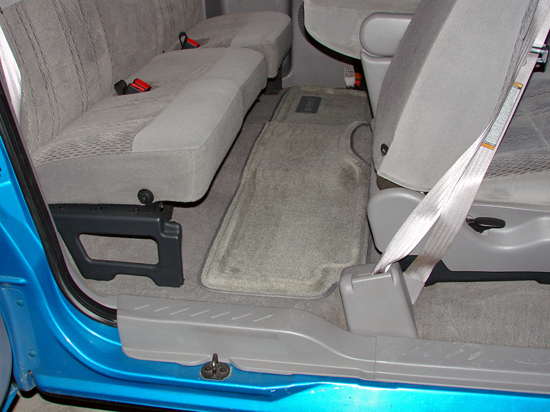 Back seat and floor mats of a blue truck