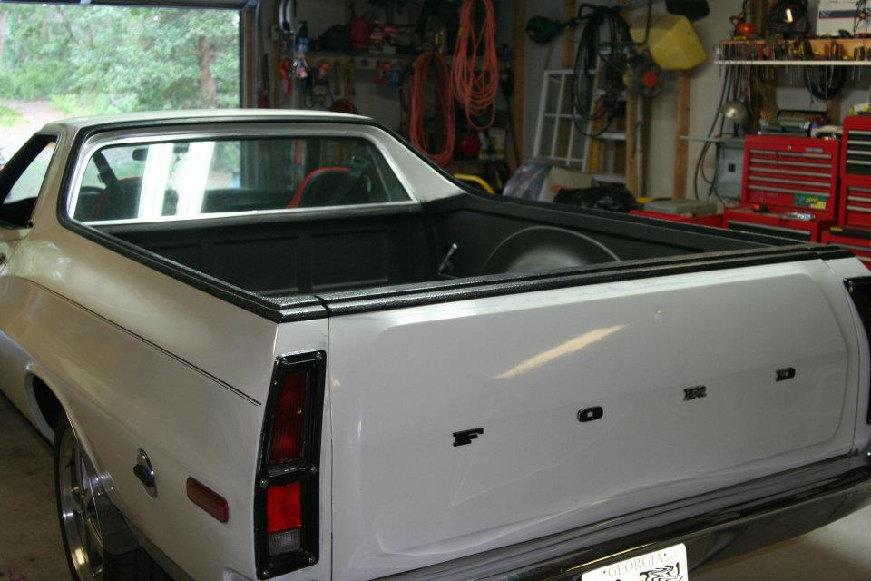 White 1976 Ford Ranchero pickup truck rear view, parked in a garage