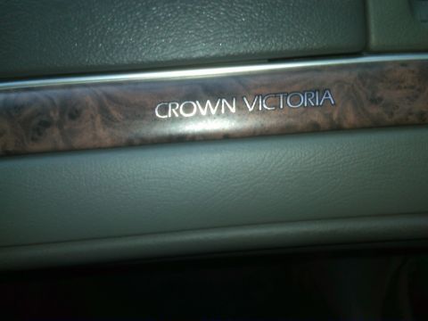 1999 Ford Crown Victoria - Close-up of the interior trim showing the Crown Victoria nameplate.