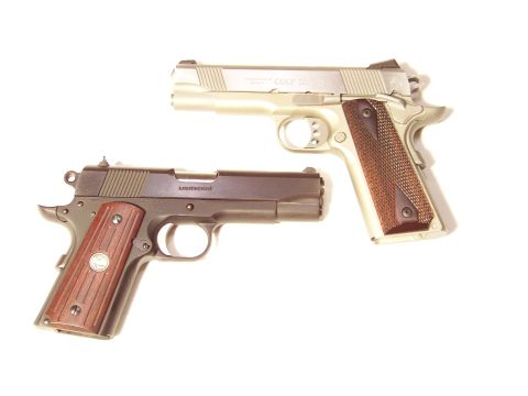 1995 Mercury Grand Marquis - Two semi-automatic pistols are displayed against a white background.