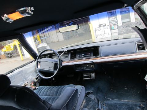 1991 Ford Crown Victoria LTD - The interior of a 1991 Ford Crown Victoria LTD shows some disassembly, with exposed wiring and removed panels.