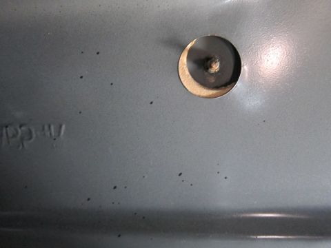 1991 Ford LTD Crown Victoria - Close-up of a gray interior panel showing a circular cutout and faint embossed text that appears to read 'PP.CAV'.