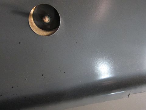 1991 Ford LTD Crown Victoria - A hole with a screw is visible on a gray surface, possibly a car part.