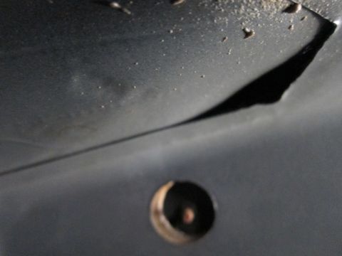 1991 Ford LTD Crown Victoria - Close-up view of the underside of a vehicle, showing a circular opening.