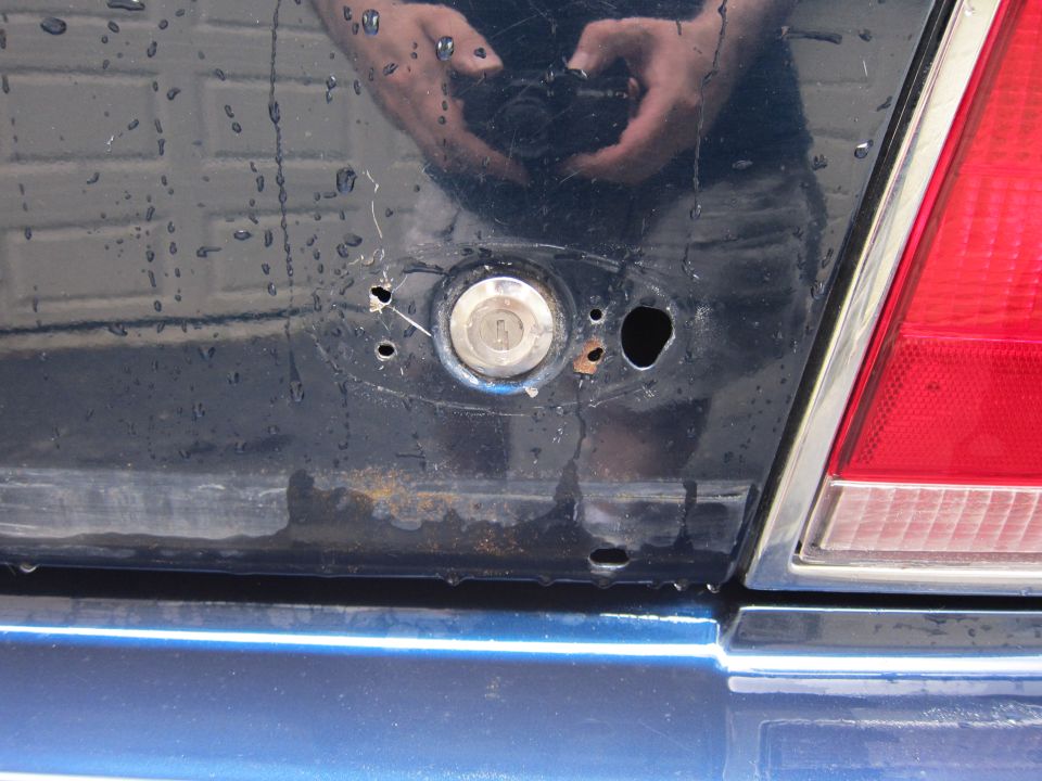 Dark blue car rear with keyhole and red taillight
