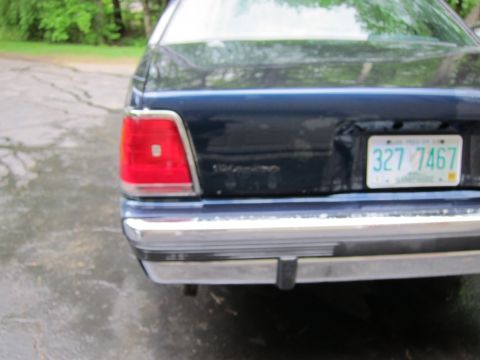 1991 Ford LTD Crown Victoria - Dark blue sedan's rear end, showing taillight and license plate.