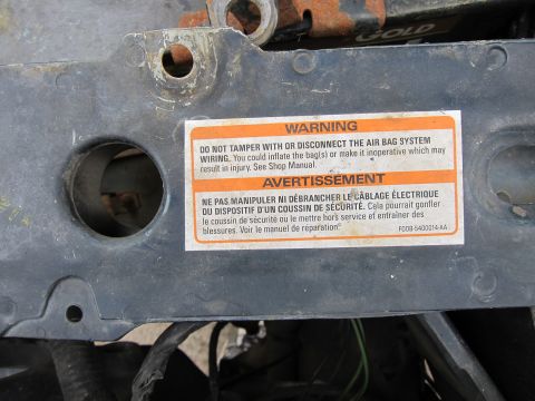1991 Ford LTD Crown Victoria - Warning label about tampering with the airbag system is affixed to a metal component.
