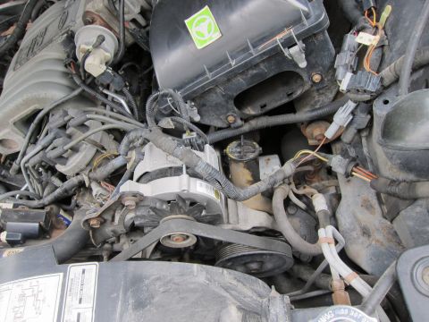 1991 Ford LTD Crown Victoria - Close-up view of a car's engine bay, showing various mechanical components and electrical wiring.