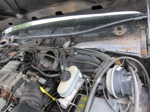 1991 Ford LTD Crown Victoria - Close-up view of engine bay components, including the brake fluid reservoir and various wiring harnesses.